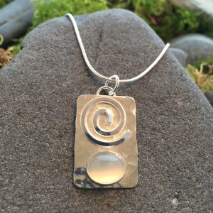 Saucy Jewelry rectangular pendant with spiral and large gemstone