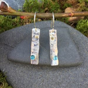 blue Swiss gemstones embedded in reticulated silver earrings
