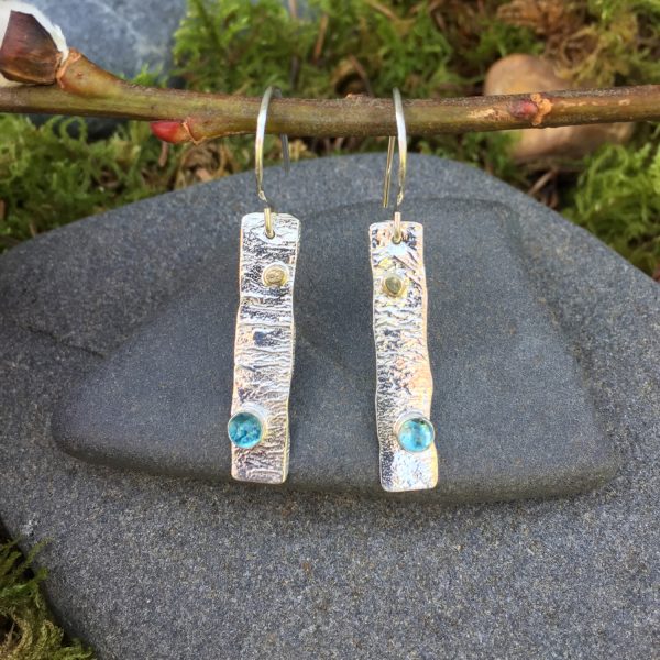 blue Swiss gemstones embedded in reticulated silver earrings