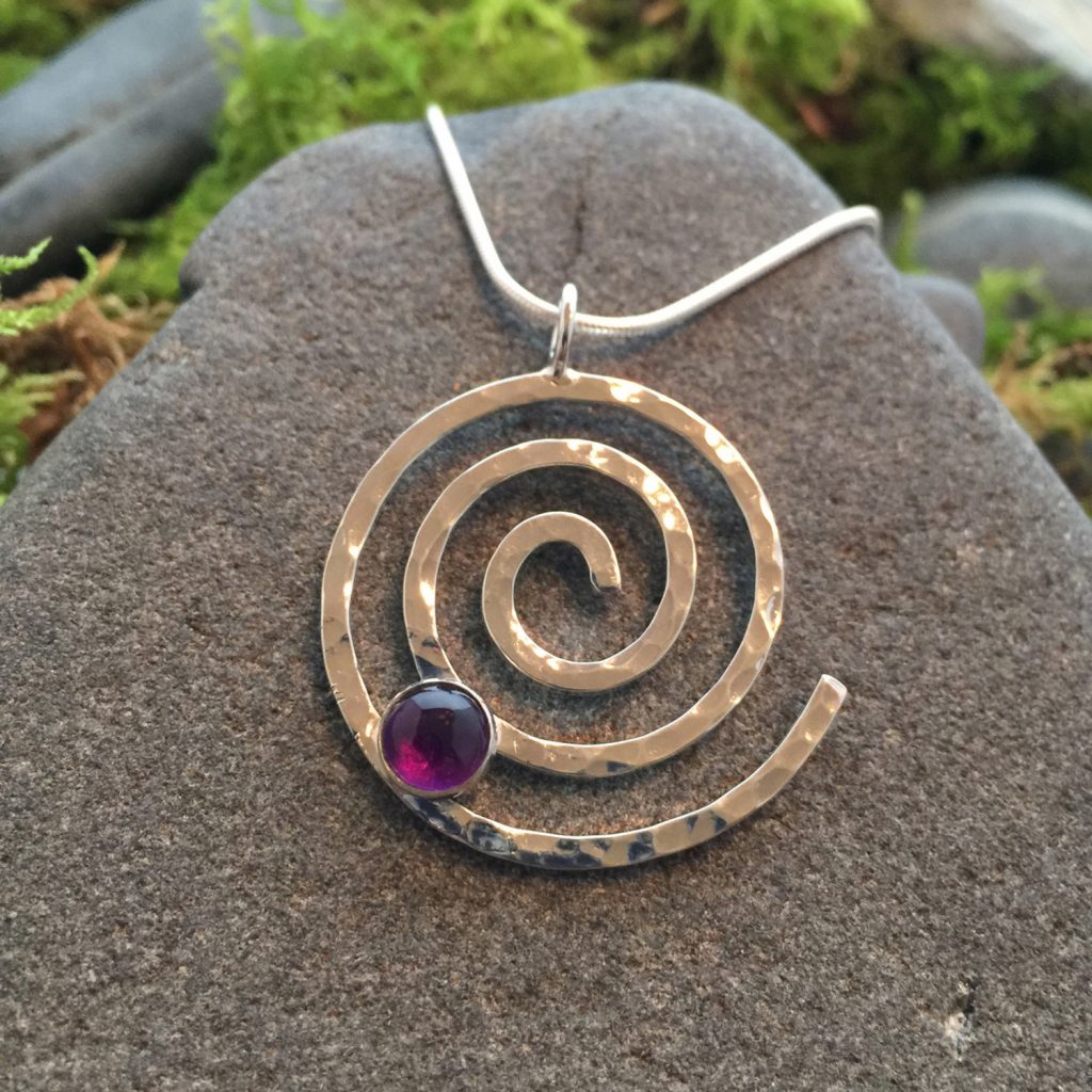 Saucy Jewelry spiral pendant with red gem