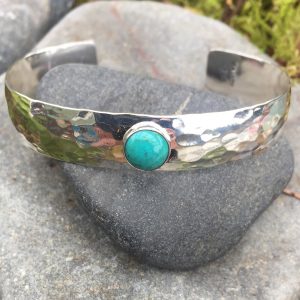 wide textured cuff with a gemstone by Saucy Jewelry